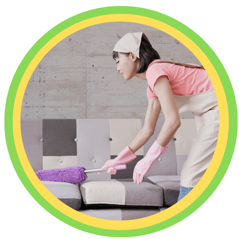 Homemaking caregiver cleaning a living room sofa, providing non-medical home care and household assistance in Hawley and Scranton, PA
